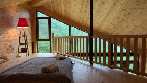 a bedroom with a bed in a wooden cabin at IparAlto in Mestia