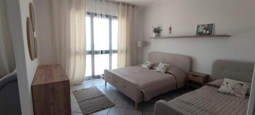 a small bedroom with a bed and a couch at Magnolia Rooms - Val Di Chy in Val di Chy