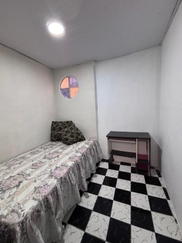 a bedroom with a bed and a table in it at BECO 6 house in Petrópolis