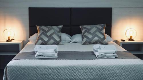 a bedroom with a large bed with two towels on it at Mini B&B - Alessandro Volta in Rende