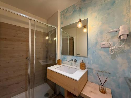 a bathroom with a sink and a shower at Casa Tritão - Gerês in Campo do Gerês