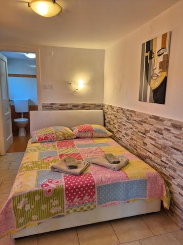 a bedroom with a bed with shoes on it at Studio for short stay in Rabac
