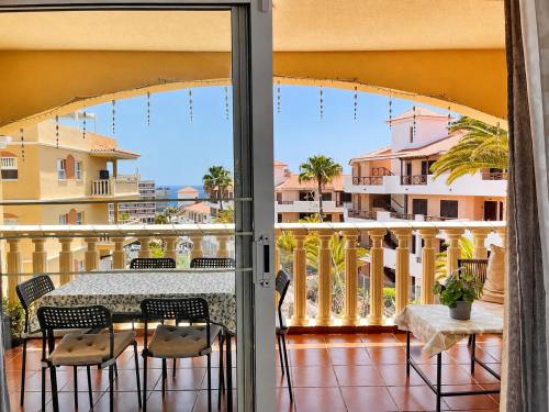 a patio with a table and chairs on a balcony at Tamaragua Apartment, Golf del Sur in San Miguel de Abona