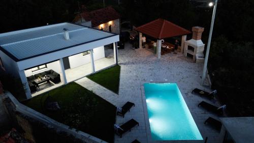 an overhead view of a swimming pool in front of a house at Villa Dub in Stolac