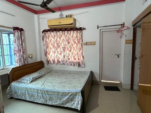 a bedroom with a bed and a suitcase on the wall at Peaceful Living in Kolkata