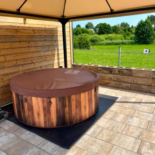 a large wooden tub sitting inside of a tent at Domek Chabrowy Gowidlino in Gowidlino