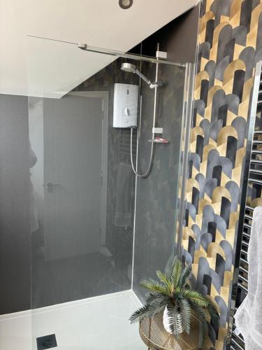 a shower with a glass door in a bathroom at Loughshore, Large Detached House, Jordanstown in Newtownabbey
