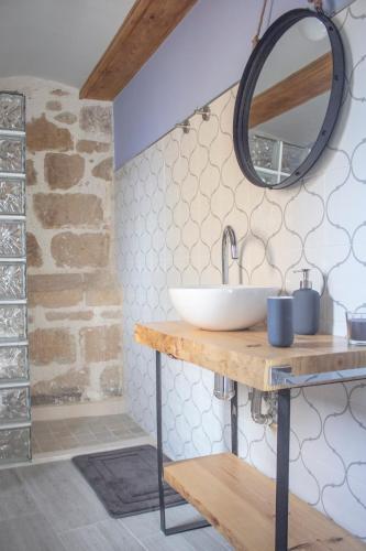 a bathroom with a sink and a mirror at Casa Rural El Morral in La Mata de los Olmos