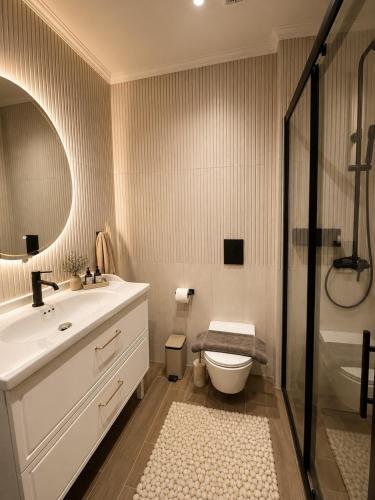 a bathroom with a sink and a toilet and a shower at Noema Park View in Xanthi