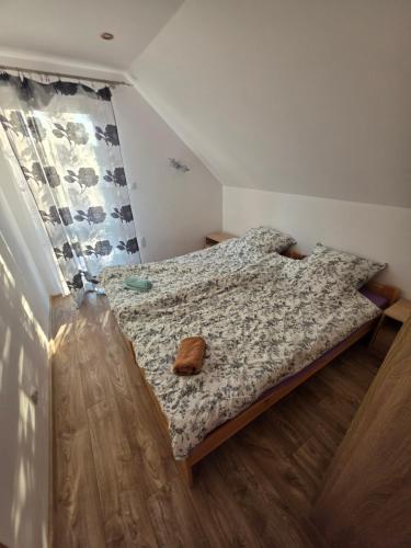a bedroom with a bed with a teddy bear on it at Domek Rosa in Bachlowa