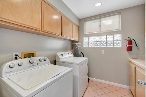 a kitchen with a white washer and dryer at OCEAN FRONT - STUNNING VIEWS- VACATION PARADISE!! in Dana Point