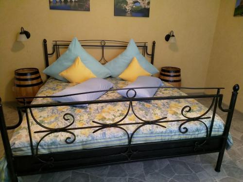 a bedroom with a bed with pillows on it at CasaVitis "Erholung am Weinberg" in Lontzen