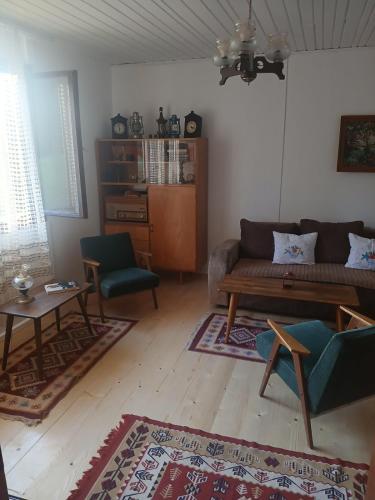 a living room with a couch and a table at Vikendica ZORA in Foča