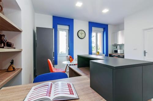 a kitchen with a table with a book on it at Sky Hostel in Zadar