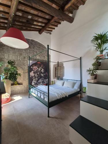 a bedroom with a metal bed in a room at PapalePapale B&B in Viterbo