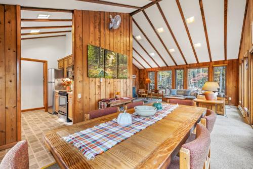 a dining room with a wooden table and chairs at Haven Home - Deck, Grill, Hiking, Pool Access, Games, Community Playground and Tennis Courts in Berkeley Springs