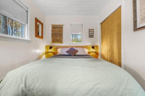 a bedroom with a large bed in a room at A Humble Abode - - Pet Friendly, Fire Pit, Deck, Grill, Wood Stove, Games, Wifi, 6 acres in Great Cacapon