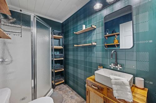 a bathroom with a sink and a shower at A Humble Abode - - Pet Friendly, Fire Pit, Deck, Grill, Wood Stove, Games, Wifi, 6 acres in Great Cacapon