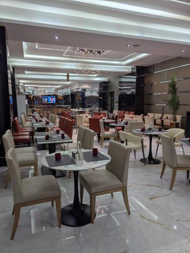 a restaurant with tables and chairs in a room at Townplace Hotel & Apartments in Port Harcourt