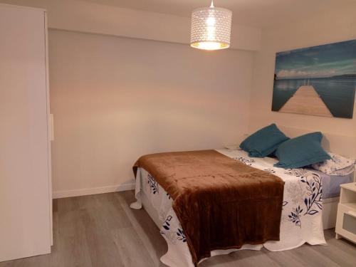 a bedroom with a bed and a painting on the wall at Estudios 71 Sardinero RH - Santander in Santander