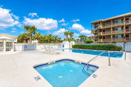a swimming pool with a building in the background at Ocean Towers Resort in Myrtle Beach