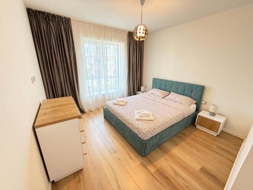 a bedroom with a bed and a large window at ThePlaceToBe2 in Brăila