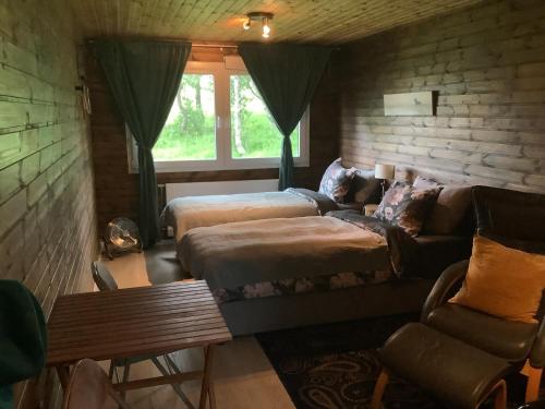 a living room with a couch and a bed at River view contryside in Reykholt