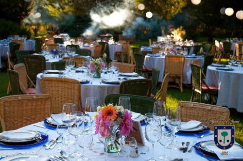 a table set up for a party with plates and glasses at Hacienda los Lingues Chile Valle de Colchagua in Los Lingues