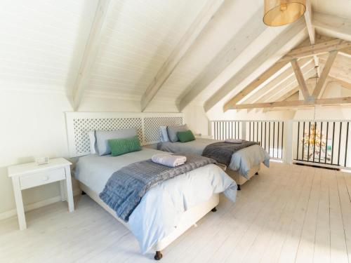 a bedroom with two beds in a attic at Luxe Pearl in Paternoster