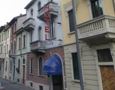 a building with a sign on the side of a street at Hotel Rallye in Milan