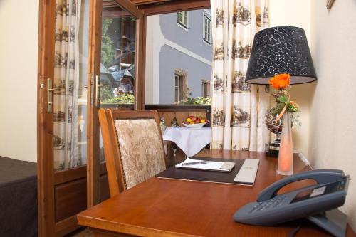 a wooden table with a phone on top of it at Seehotel Grüner Baum in Hallstatt