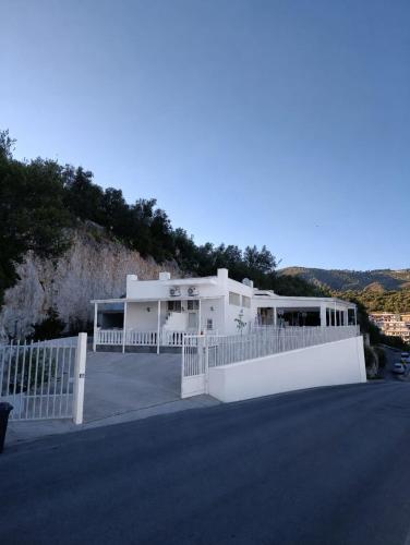 a white house with a white fence in front of it at Bed and Breakfast Brezza Marina in Mattinata