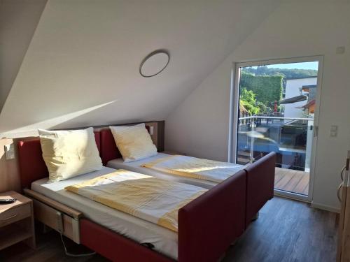 a bed in a room with a large window at Smartliving 85 in Aßlar