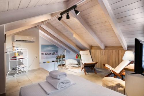 a room with wooden ceilings and a room with a bed at Hippothoi Sea View Maisonette in Mesochórion