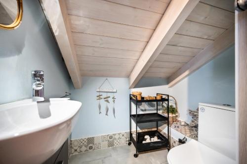 a bathroom with a sink and a toilet at Hippothoi Sea View Maisonette in Mesochórion