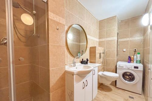 a bathroom with a sink toilet and a mirror at Bright 2 Bedroom, Private Garden in Herzliya