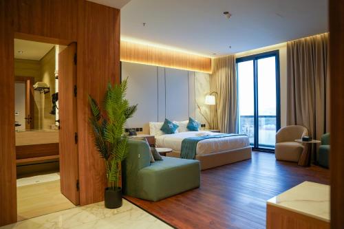 a hotel room with a bed and a couch at KH La Maison in Abha