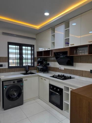 a kitchen with a washer and a dishwasher in it at 2bedroom Harmony Apartment in Abuja