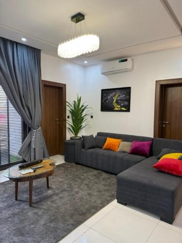 a living room with a couch and a table at 2bedroom Harmony Apartment in Abuja