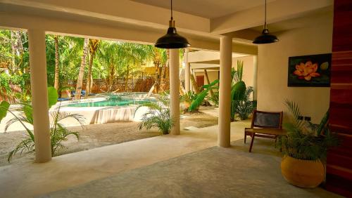 a house with a swimming pool and a patio at Casa del Viento by ÓOL Hotels in Holbox Island