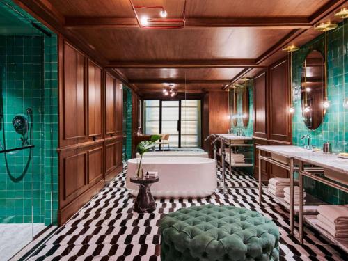 a bathroom with a tub and a sink and a bath tub at Virgin Hotels New Orleans in New Orleans