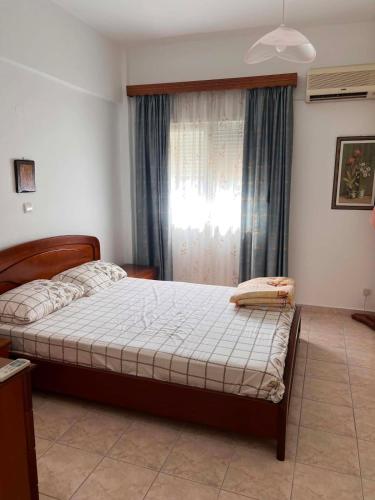 a bedroom with a bed and a window at Theofania House Kanali in Kanali