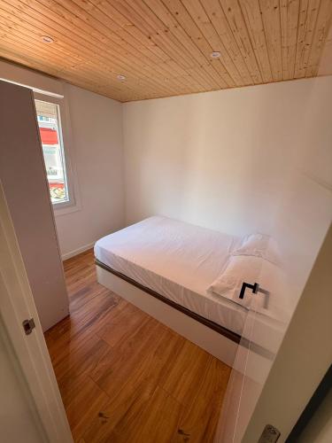 a bedroom with a bed with a wooden ceiling at Agasallo Cedeira in Cedeira