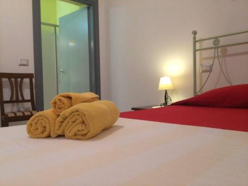 a towel animal sitting on top of a bed at B&B Is Janas E5391 in Fordongianus