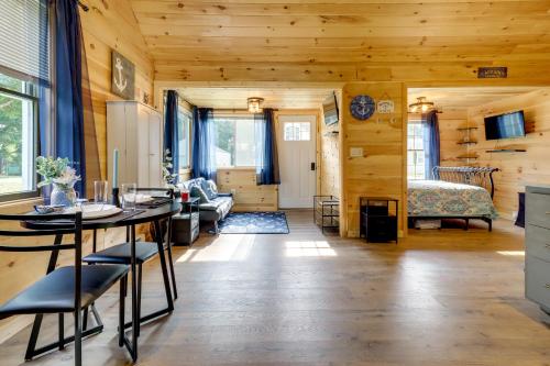 a living room with a table and a bedroom at Fire Pit, Gas Grill! Bright Cottage By Devils Lake in Manitou Beach