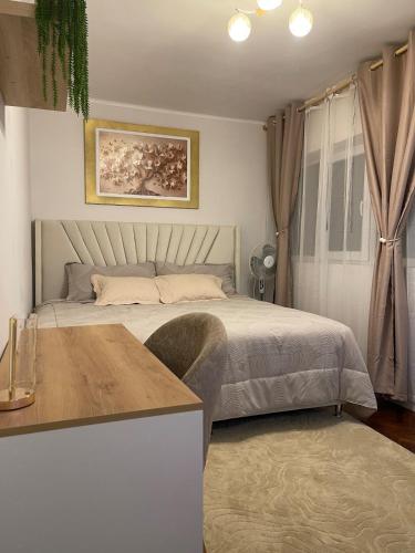 a bedroom with a bed and a table at Mini Apartment Ares 3 in Lima