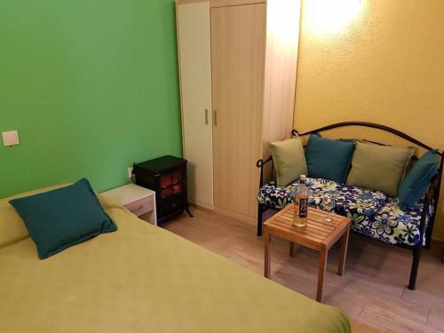 a room with a bed and a couch and a table at Calypso's Cave the Apartment for Animal Lovers in Babino Polje