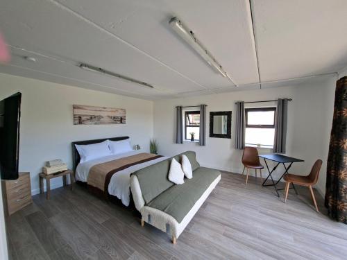 a bedroom with a bed and a couch and a television at Bundoran Holiday Letting in Bundoran