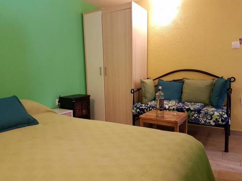 a hotel room with two beds and a couch at Calypso's Cave the Apartment for Animal Lovers in Babino Polje