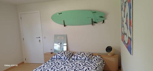 a bedroom with a bed with a surfboard on the wall at Guesthouse Thibault in Gistel